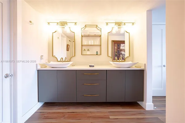 a bathroom with a double vanity sink and a mirror