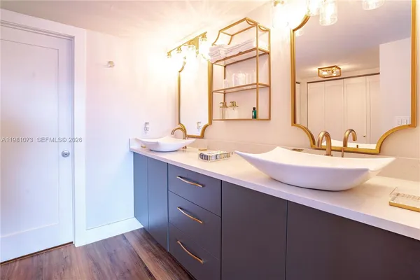 a bathroom with a double vanity sink and a mirror