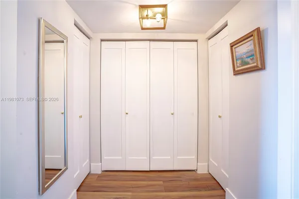 a view of a room with wooden floor and closet