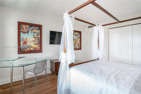 a view of a bedroom with wooden floor