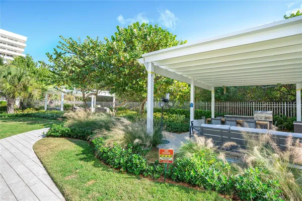 a view of a backyard with plants and patio