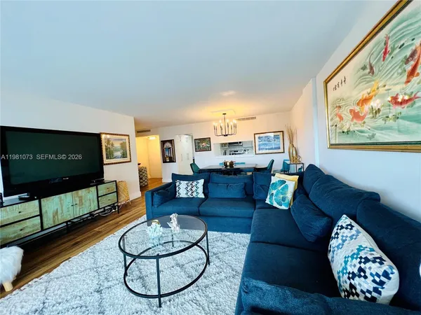 a living room with furniture a rug and a flat screen tv