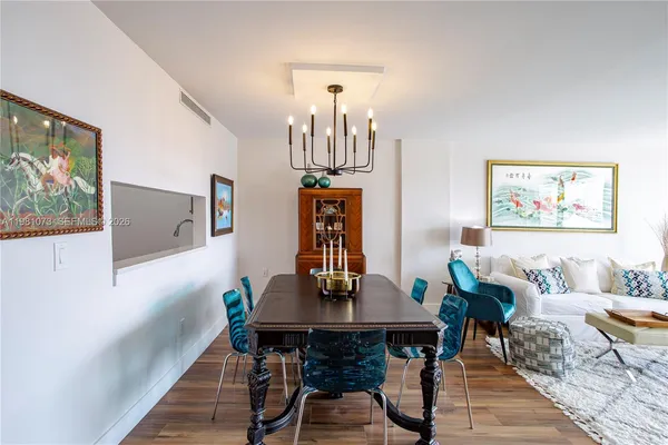a view of a dining room with furniture wooden floor and a chandelier