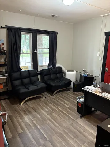 a living room with furniture window and wooden floor