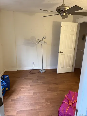 a view of a room with wooden floor