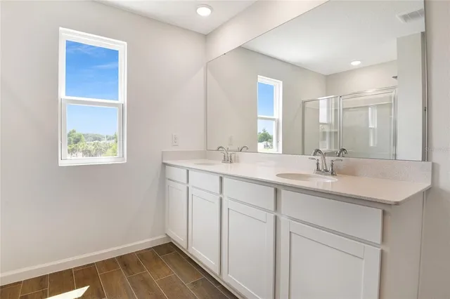 a bathroom with a shower and a glass door