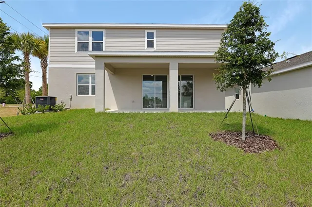 a view of a house with a backyard