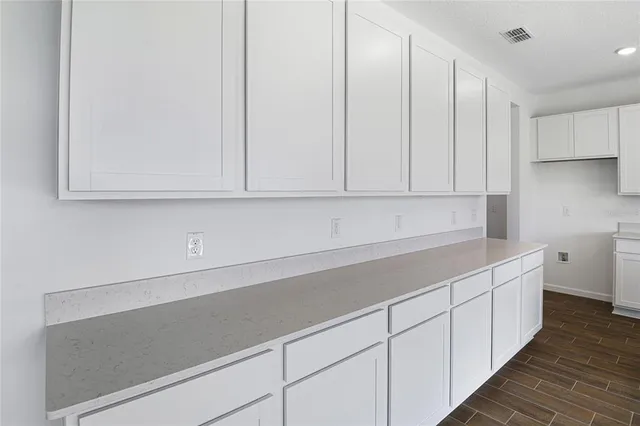 a kitchen with stainless steel appliances white cabinets and a sink