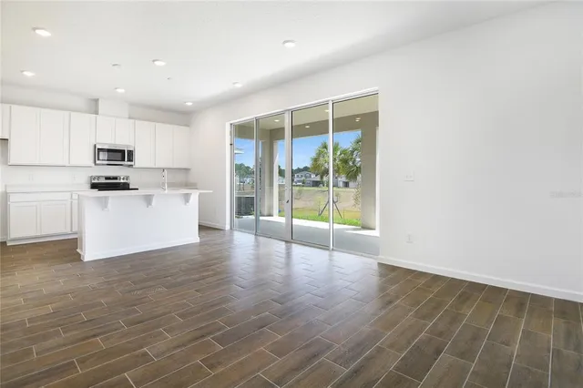 a kitchen with stainless steel appliances a refrigerator and a stove top oven