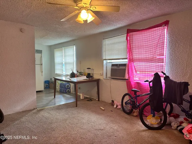a view of a livingroom with furniture and a window