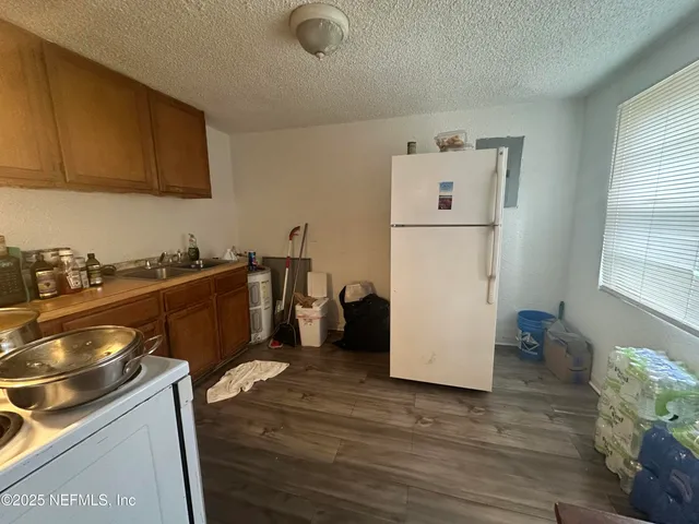 a utility room with wooden floor washer and dryer
