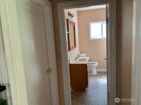 a view of bathroom with a toilet sink and mirror