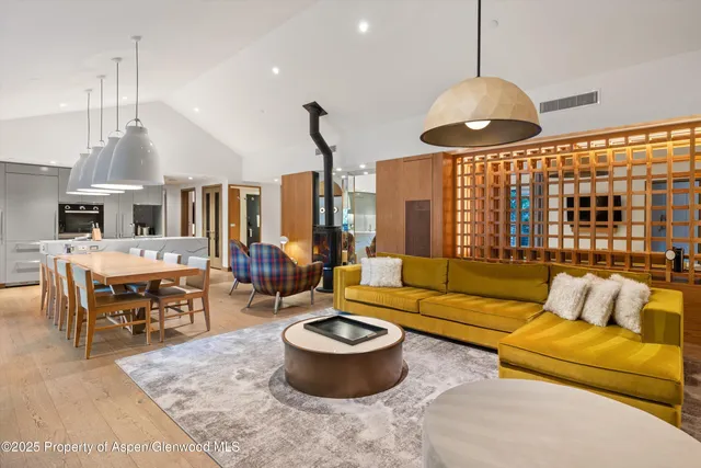a living room with furniture a window and a chandelier
