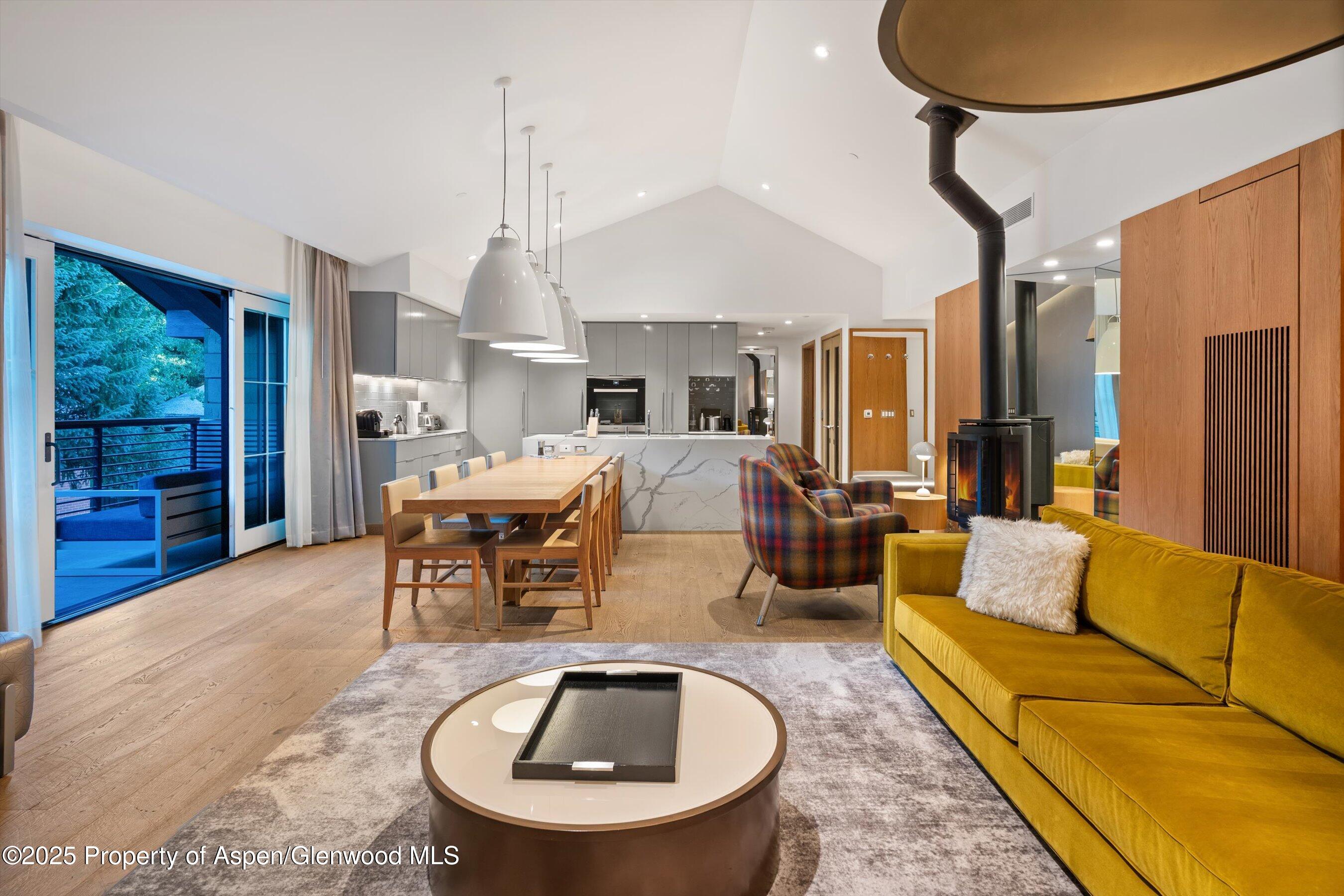 550 South Spring Street, Unit F10 110 Aspen, CO 81611 - Photo 58 of 58 a living room with furniture a window and a chandelier