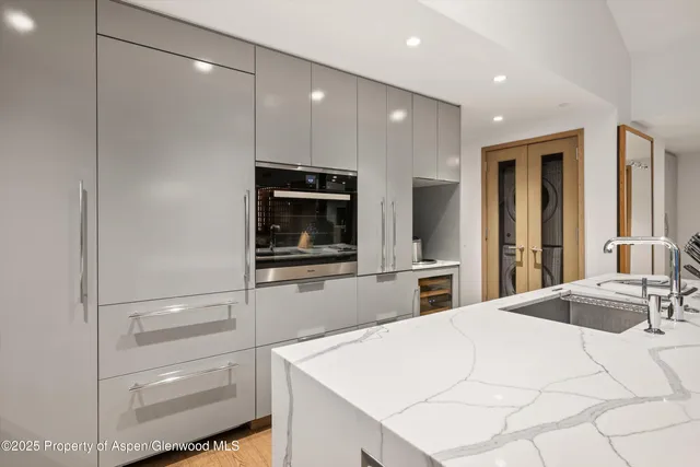 a view of kitchen with stainless steel appliances kitchen island granite countertop a refrigerator and a stove top oven