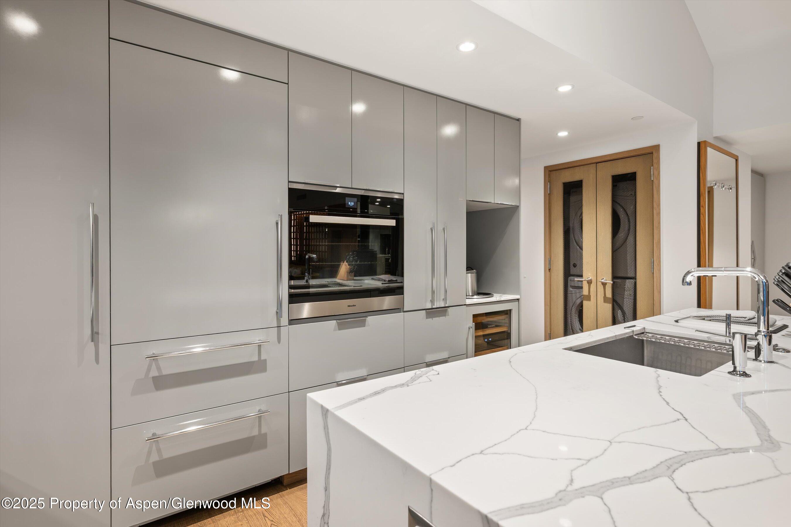 550 South Spring Street, Unit F10 110 Aspen, CO 81611 - Photo 16 of 58 a kitchen with a refrigerator and a sink