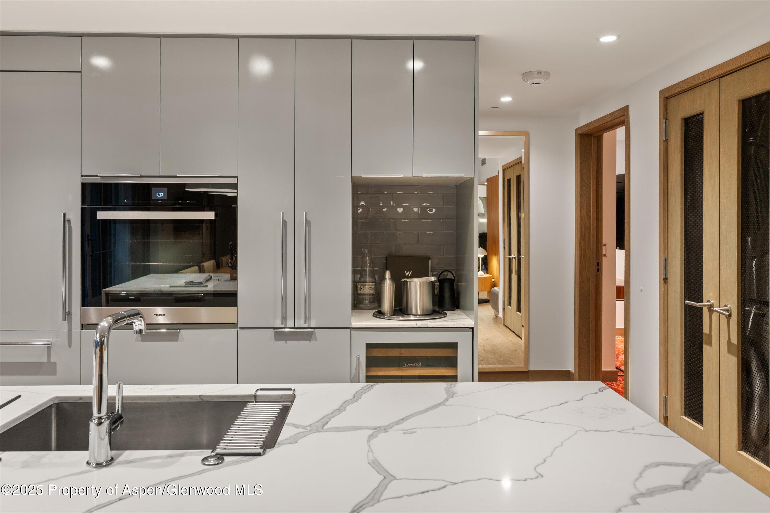 550 South Spring Street, Unit F10 110 Aspen, CO 81611 - Photo 17 of 58 a view of kitchen with stainless steel appliances kitchen island granite countertop a refrigerator and a stove top oven