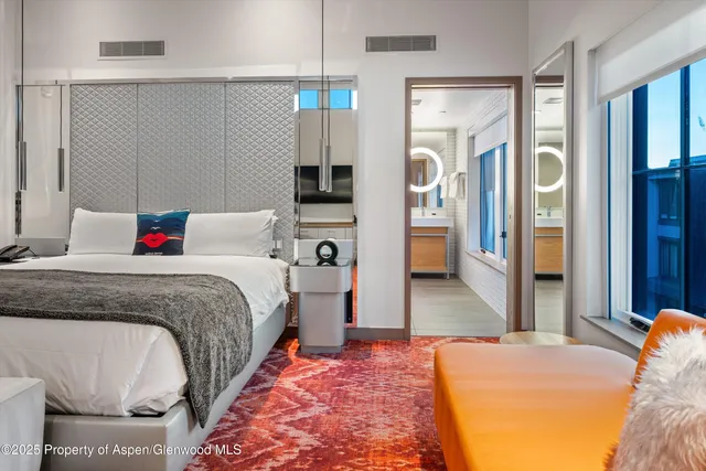 a bedroom with a bed and flat screen tv