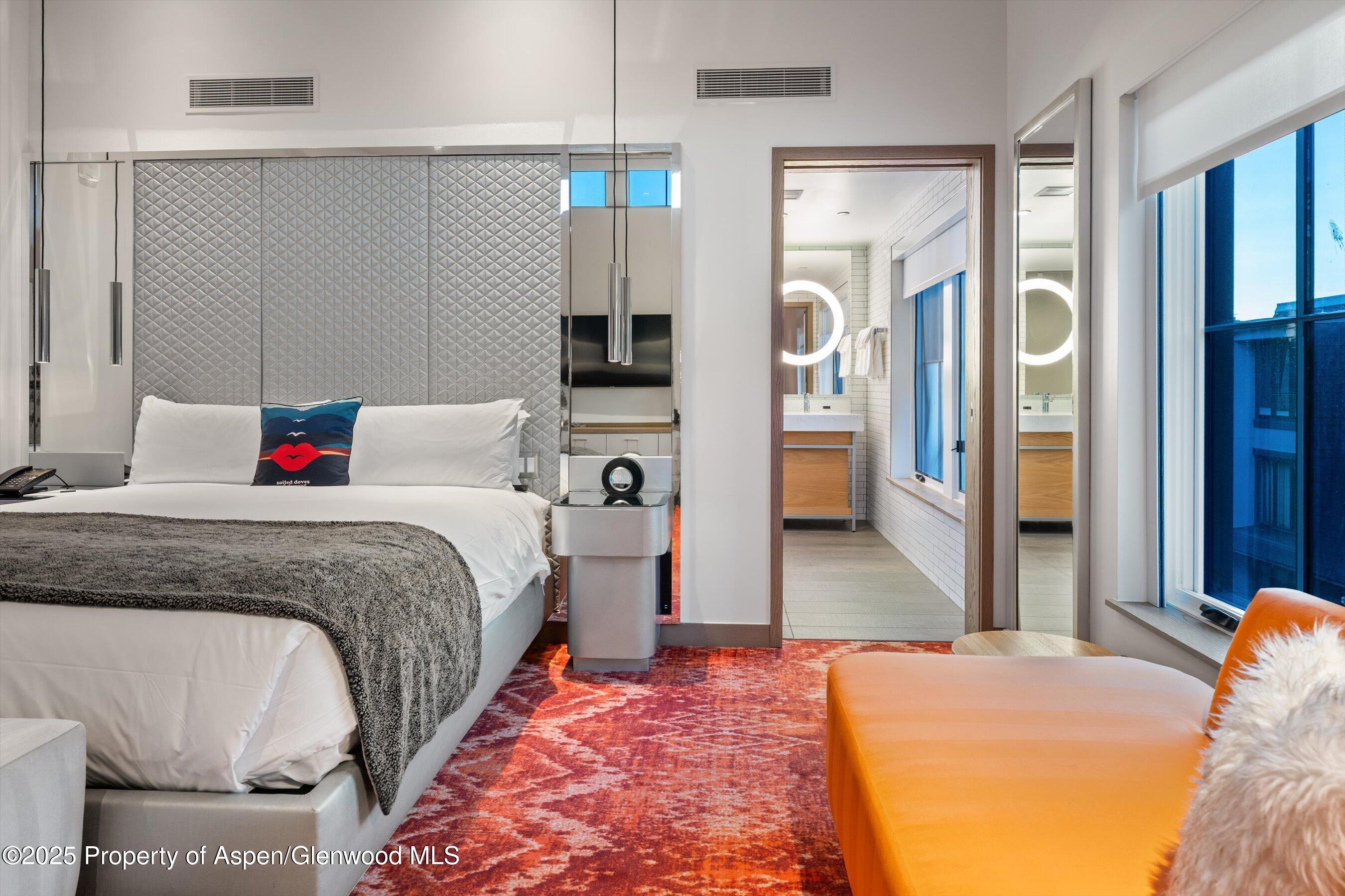 550 South Spring Street, Unit F10 110 Aspen, CO 81611 - Photo 24 of 58 a bedroom with bed and walk in closet