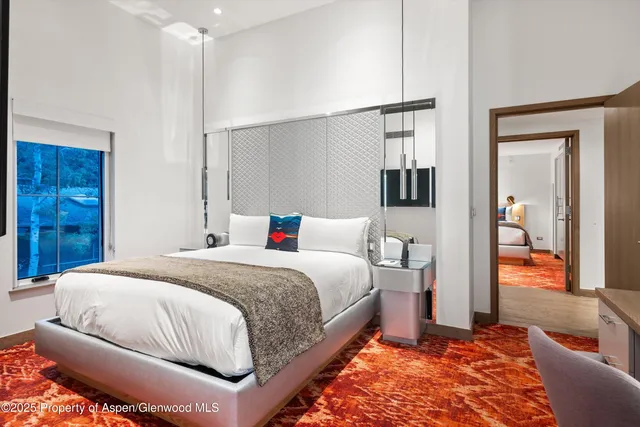 a bedroom with a bed and a table