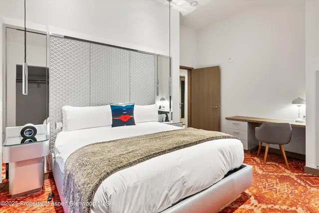 a bedroom with a bed and a dresser