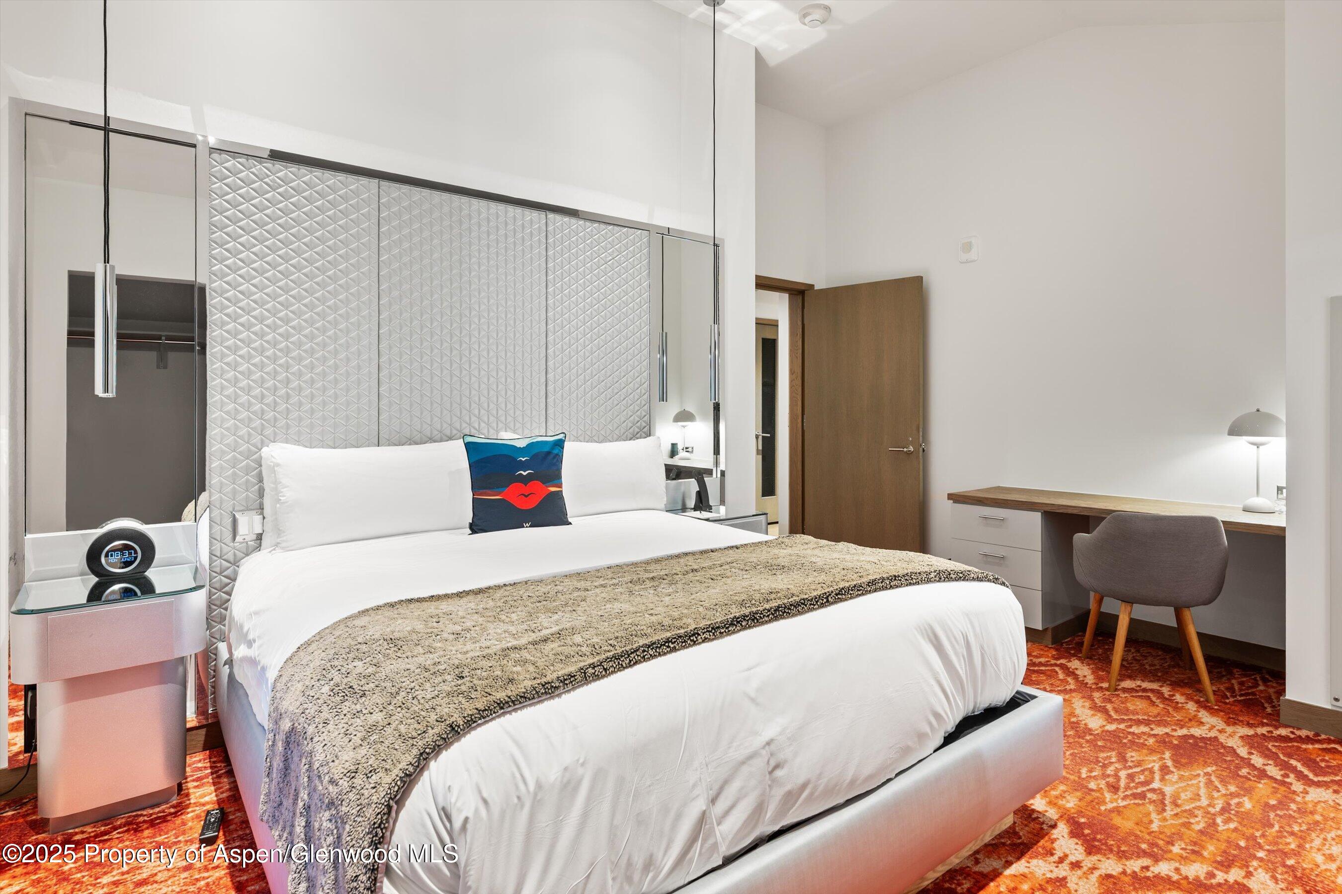 550 South Spring Street, Unit F10 110 Aspen, CO 81611 - Photo 33 of 58 a bedroom with a bed dresser and a chair