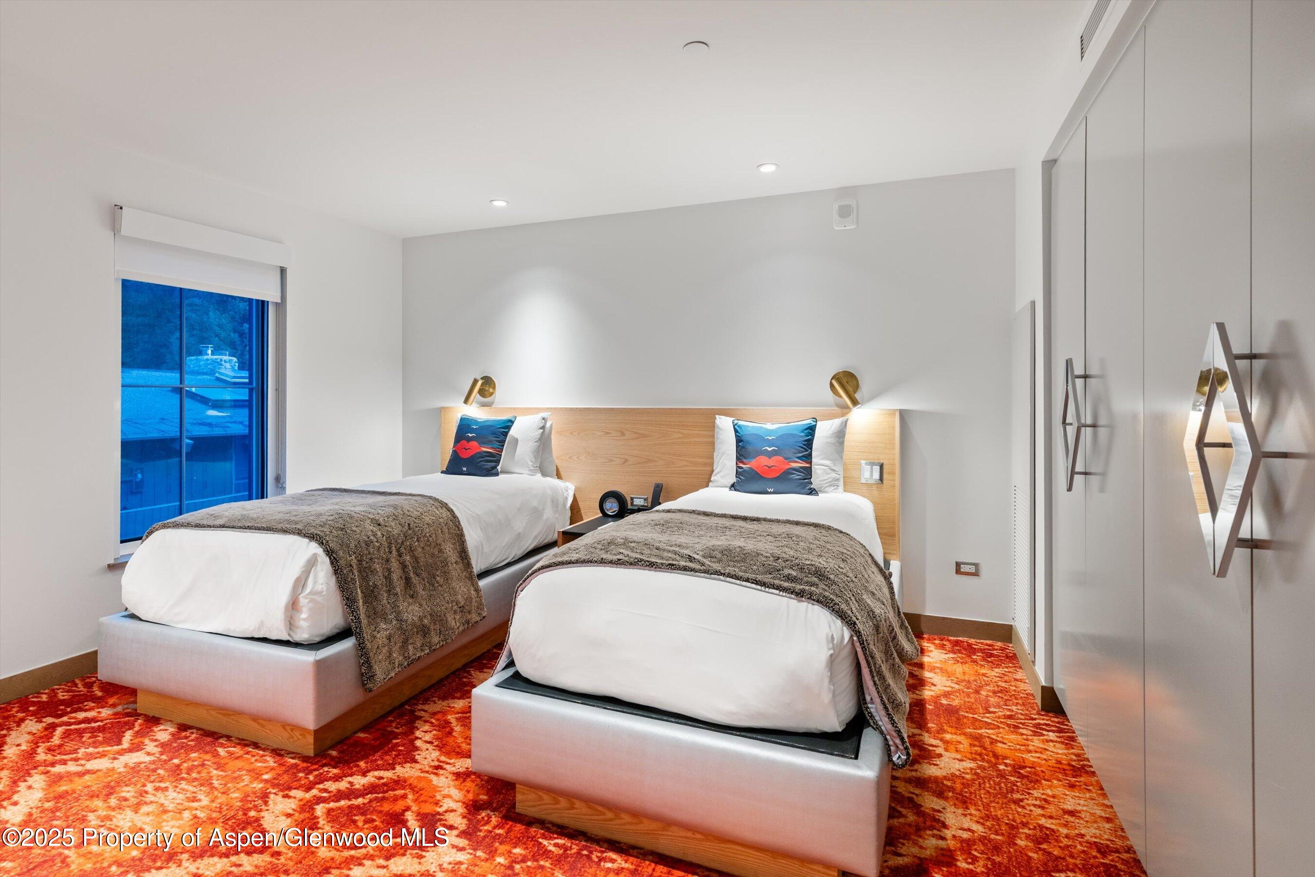 550 South Spring Street, Unit F10 110 Aspen, CO 81611 - Photo 34 of 58 a bedroom with a bed and a table