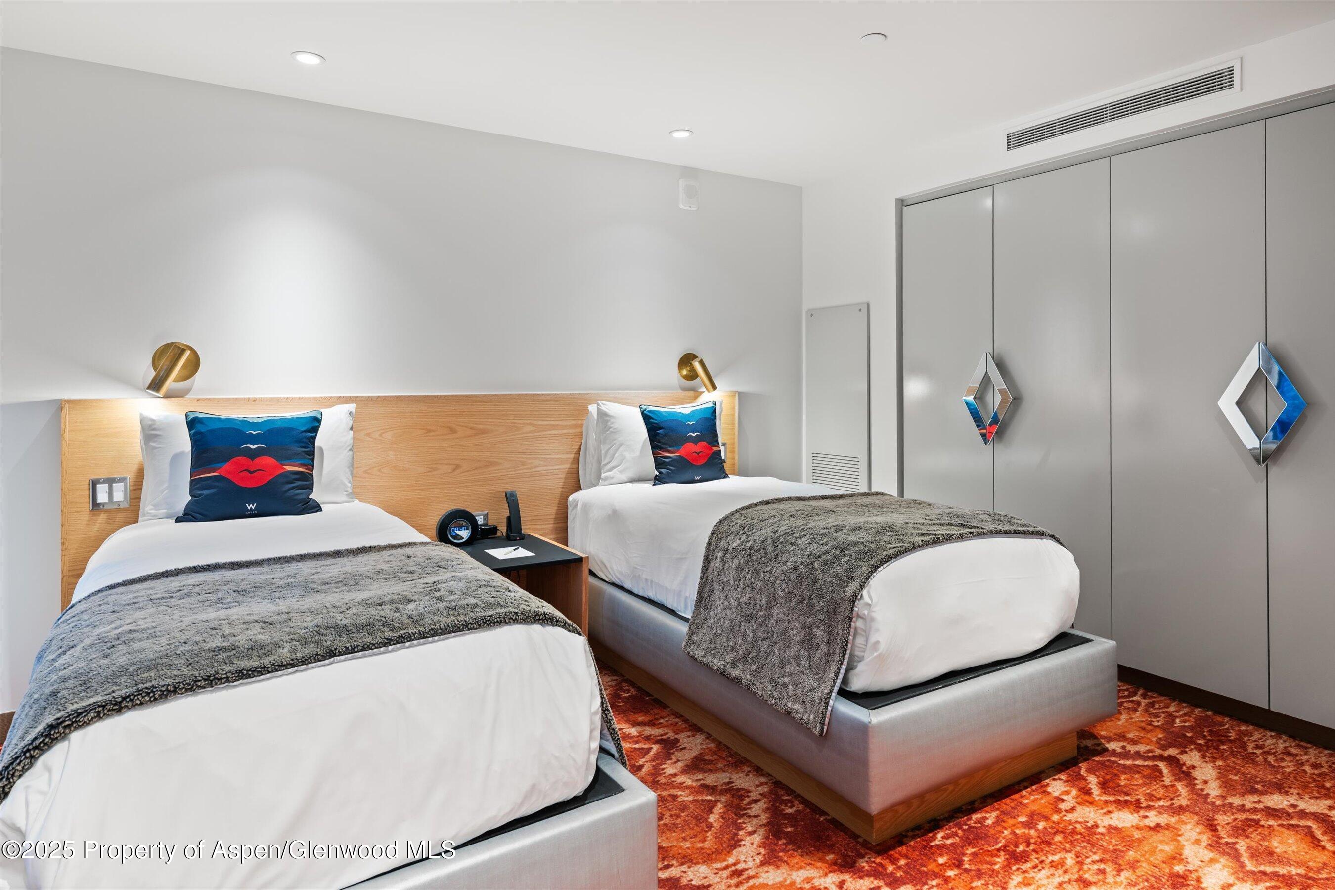 550 South Spring Street, Unit F10 110 Aspen, CO 81611 - Photo 35 of 58 a bedroom with a bed and a dresser