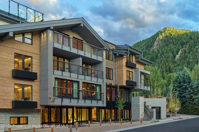 an outdoor sitting area with furniture and city view