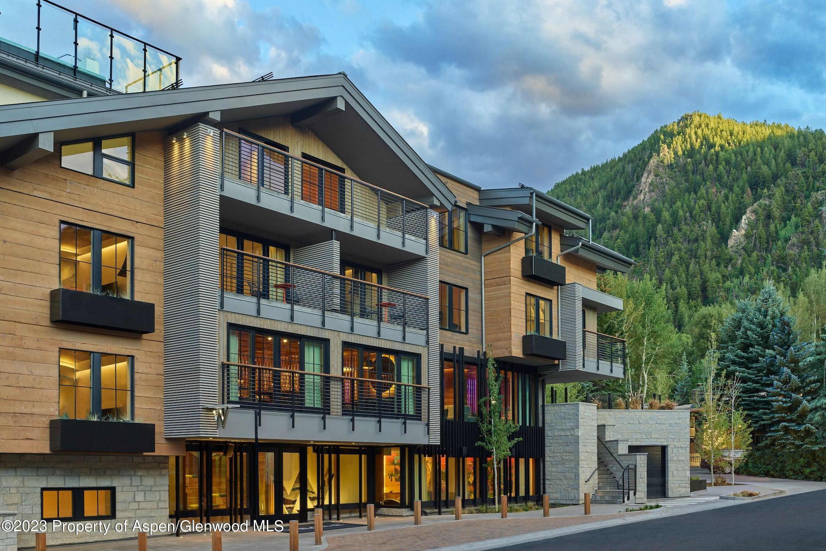 550 South Spring Street, Unit F10 110 Aspen, CO 81611 - Photo 46 of 58 a front view of a residential apartment building with a yard