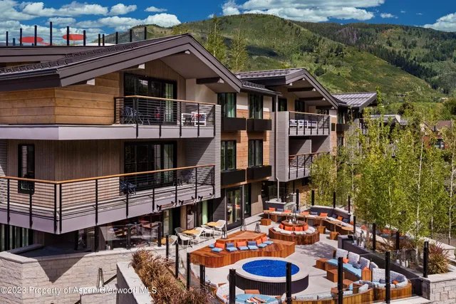 a front view of a house with swimming pool outdoor seating
