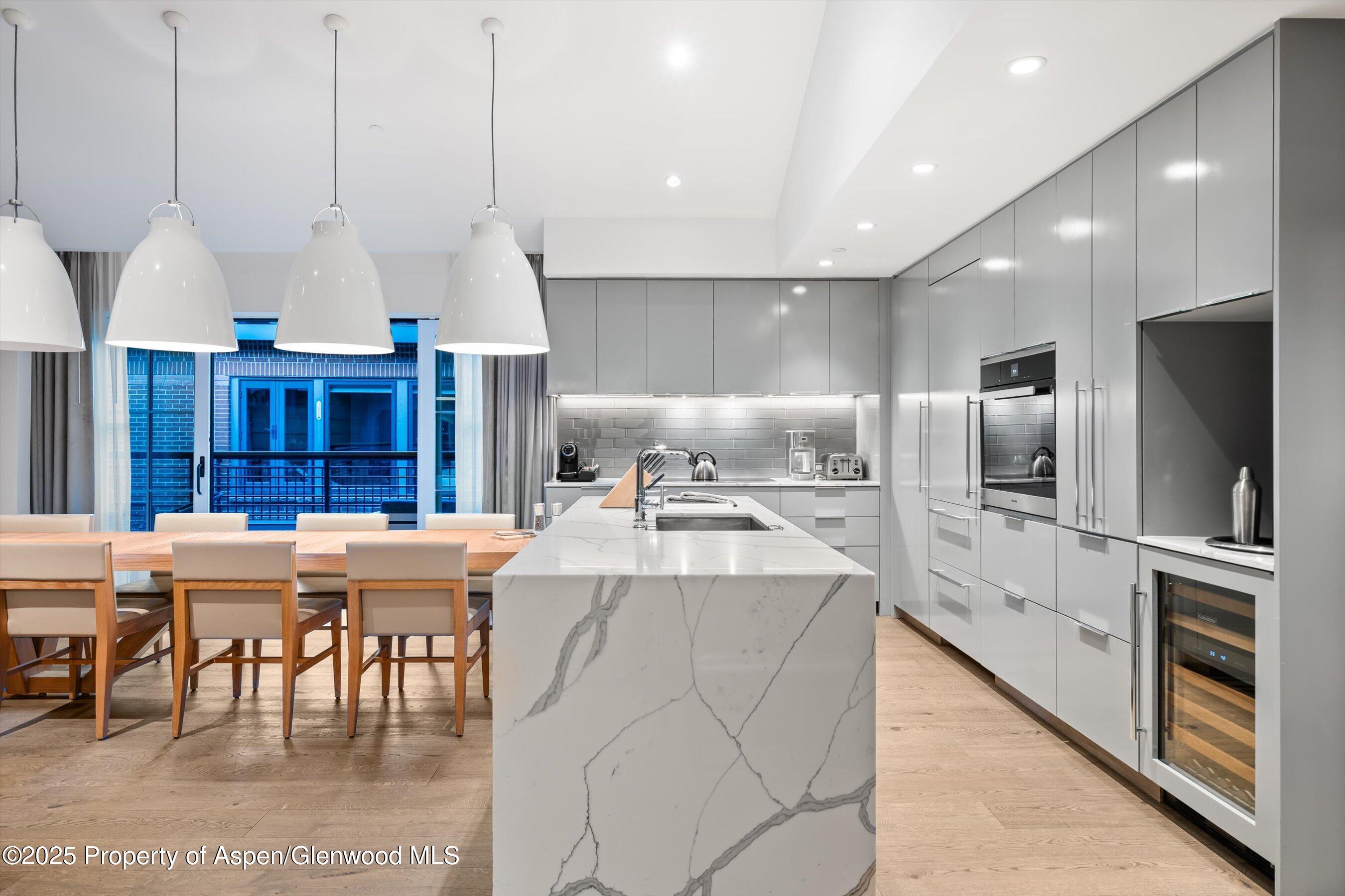 550 South Spring Street, Unit F10 110 Aspen, CO 81611 - Photo 8 of 58 a large kitchen with a table and chairs