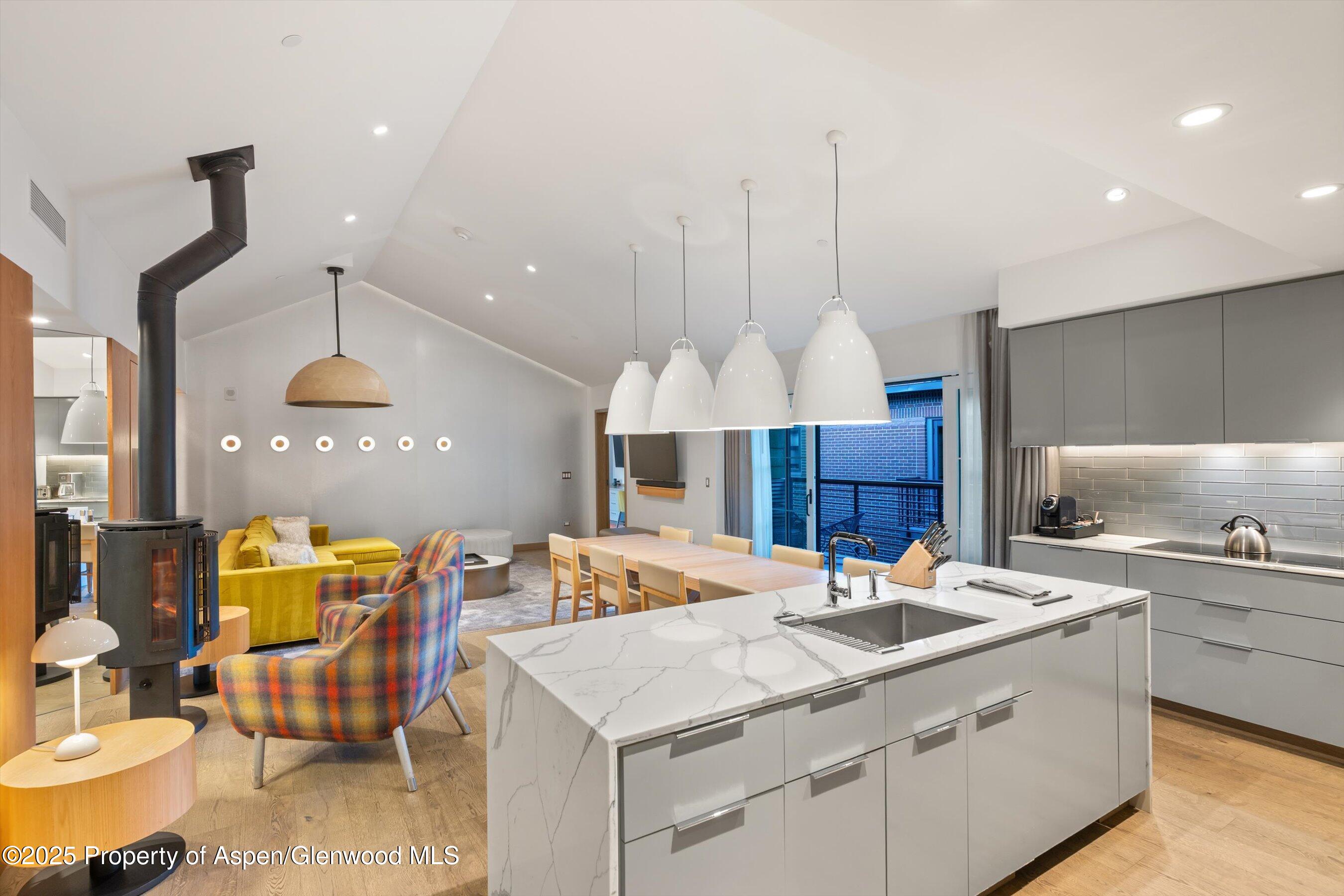 550 South Spring Street, Unit F10 110 Aspen, CO 81611 - Photo 9 of 58 a kitchen with a sink appliances and a chandelier