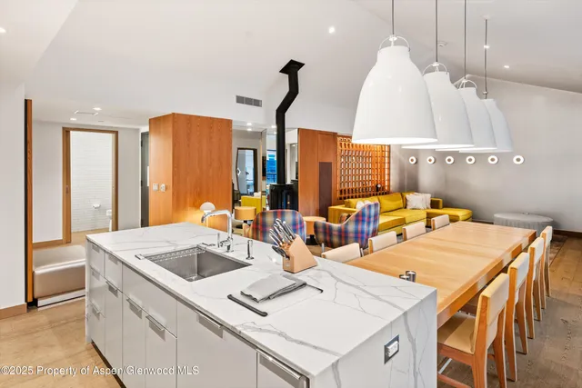 a living room with furniture kitchen and a chandelier