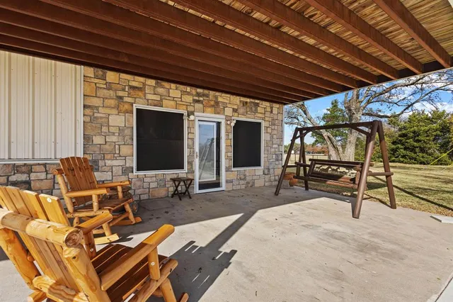 a view of a patio with table and chairs