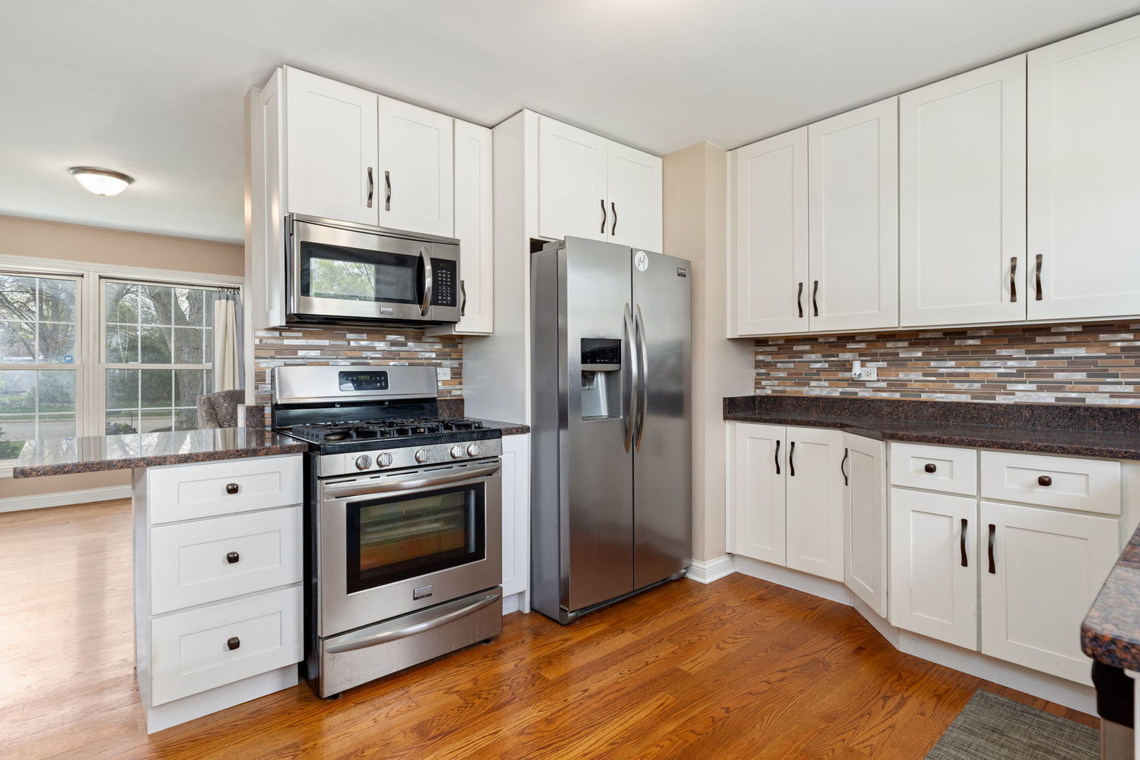 575 Aztec Drive Carol Stream, IL 60188 - Photo 9 of 20 a kitchen with stainless steel appliances granite countertop a stove a refrigerator and a microwave