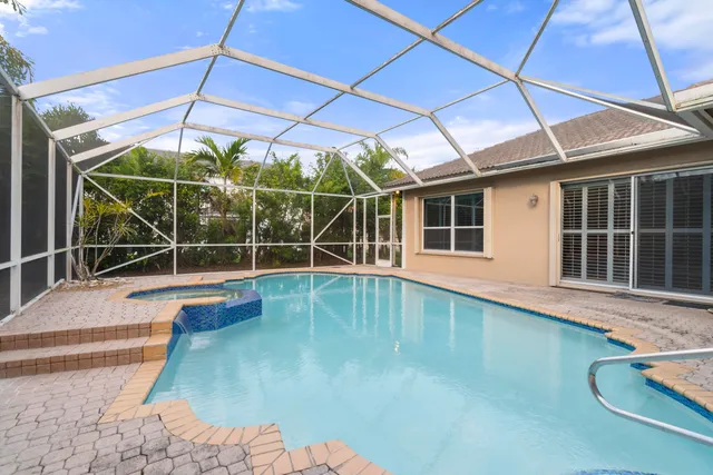 a view of a backyard with a swimming pool