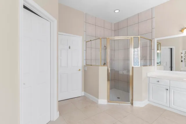 a bathroom with a shower and a glass door