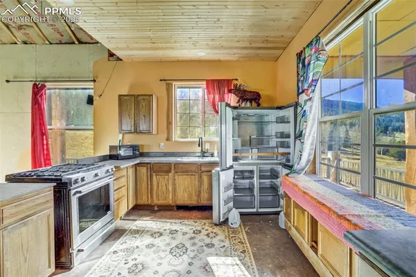 a kitchen with stainless steel appliances granite countertop a stove and cabinets