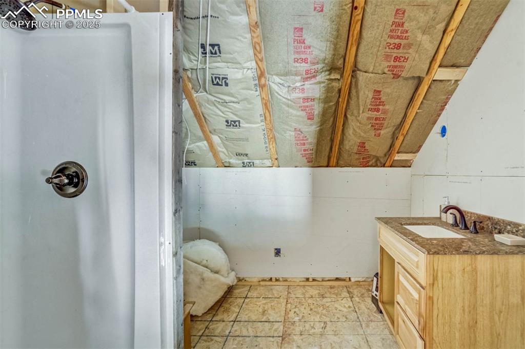 1440 Range Road Guffey, CO 80820 - Photo 27 of 50 a bathroom with a granite countertop sink and a mirror