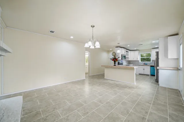 a view of a kitchen with a sink stainless steel appliances and cabinets