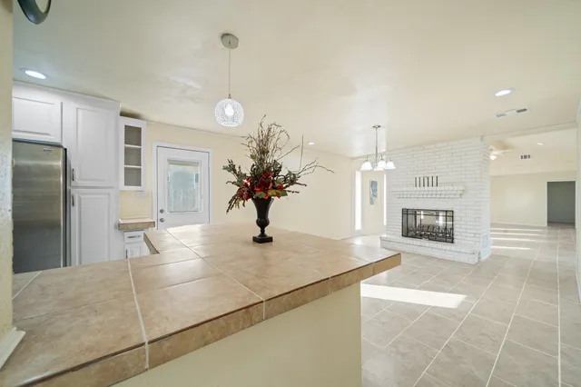 a view of kitchen with sink and refrigerator