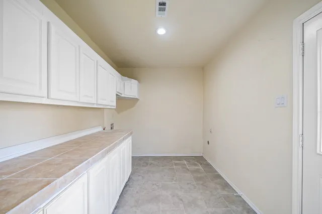 a view of a kitchen with granite countertop cabinets