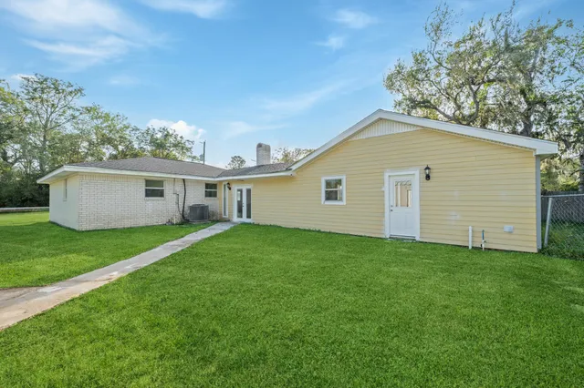 a view of a backyard with a garden and entertaining space