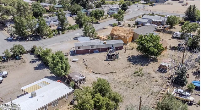 an aerial view of a house with a yard and lake view