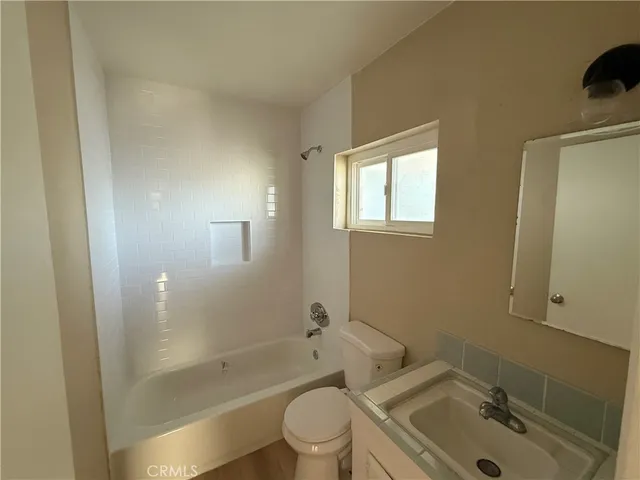 a kitchen with a sink a refrigerator and cabinets