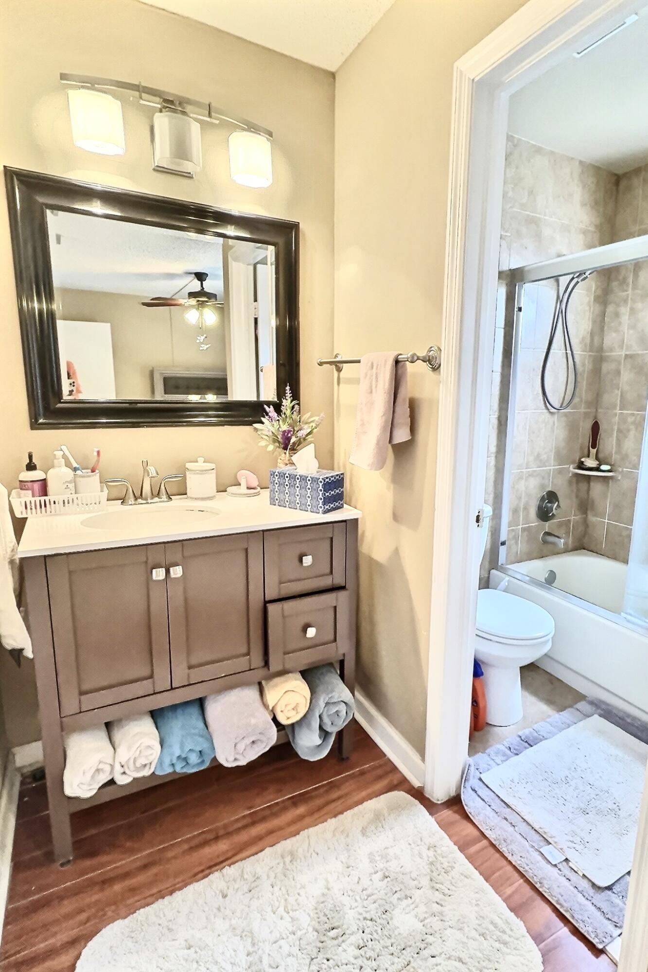 6663 Via Regina Boca Raton, FL 33433 - Photo 11 of 16 a bathroom with a granite countertop sink and a mirror