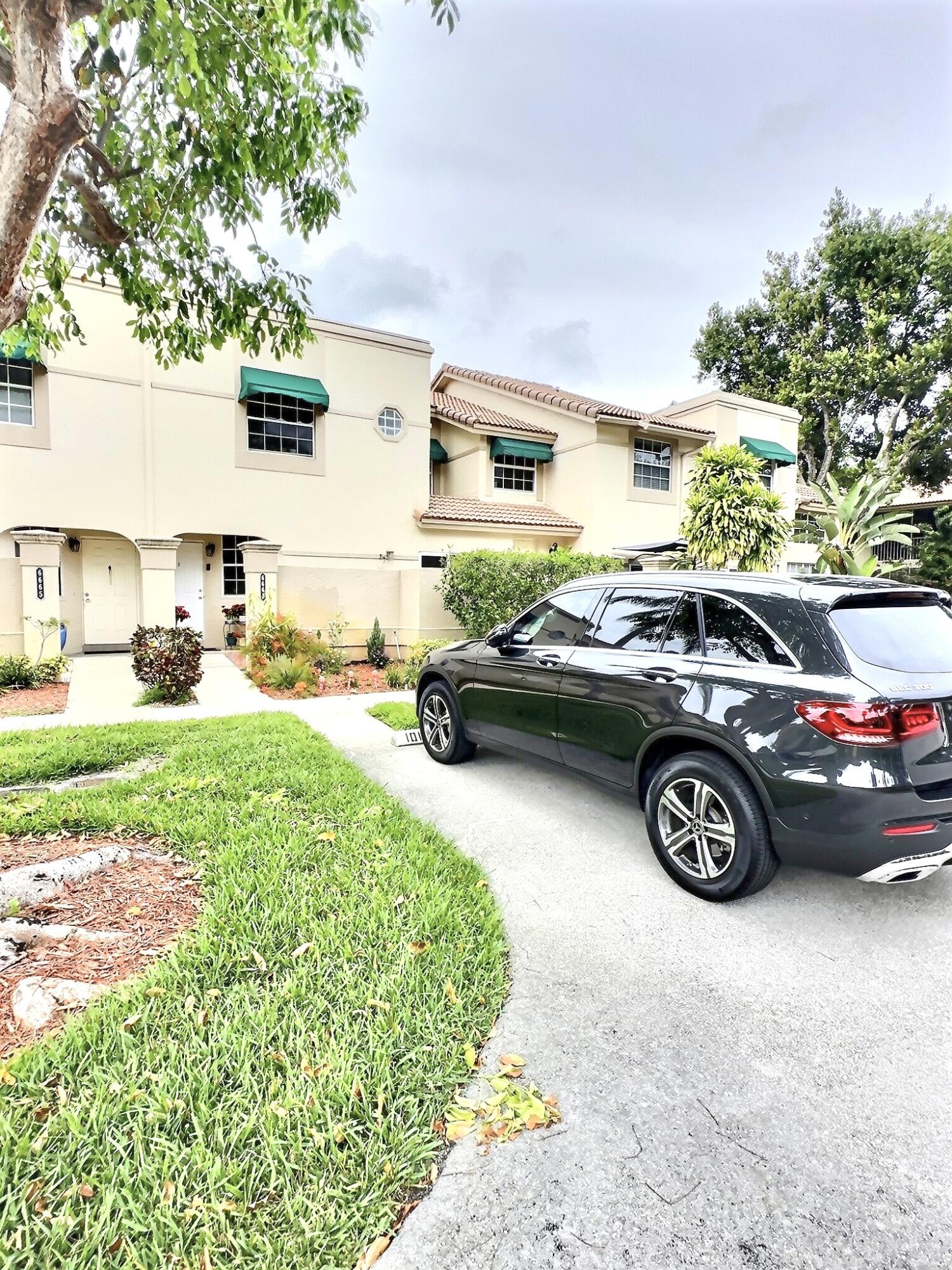 6663 Via Regina Boca Raton, FL 33433 - Photo 13 of 16 a car parked in front of a house