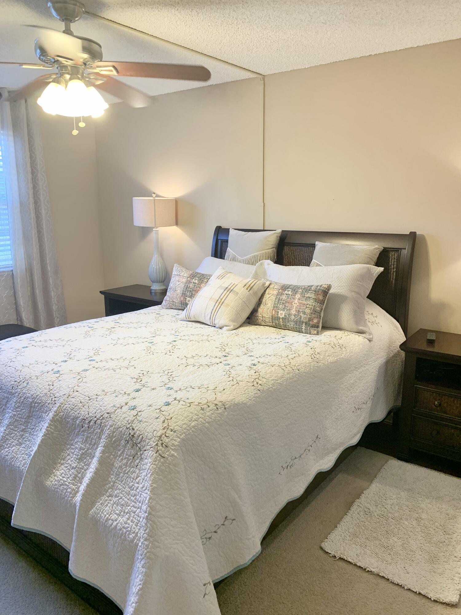 6663 Via Regina Boca Raton, FL 33433 - Photo 10 of 16 a bedroom with bed and a chandelier