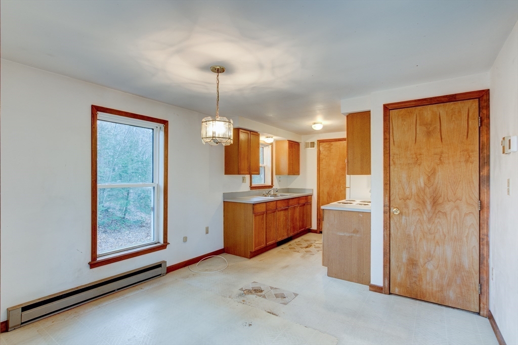 70 Ashburnham State Road Westminster, MA 01473 - Photo 9 of 32 a view of a kitchen with a refrigerator a sink and wooden floor